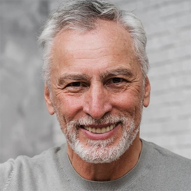 A smiling gray-haired man